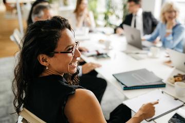 Team members interacting around a conference table