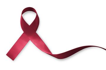 A dark red ribbon signifies Sickle Cell Awareness Month