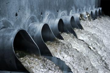 Water flows out of a series of pipes in a water treatment plant