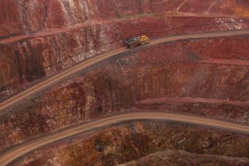 A dump truck driving out of a copper mine