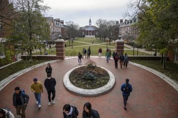Students walk around the Homewood campus on a grey winter day