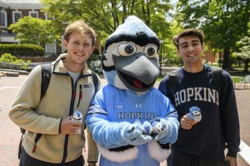 People smile with the Blue Jay mascot