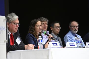 A person speaking on a panel