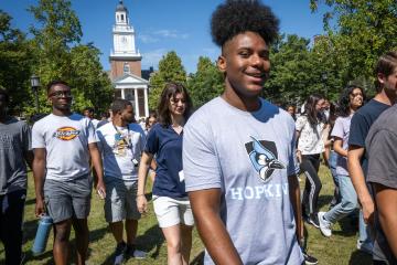 Brian Robinson, a Johns Hopkins University freshman, walks with other incoming students on the campus in Baltimore