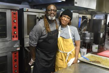 Matthew and Tia Raiford smile for the camera in a kitchen