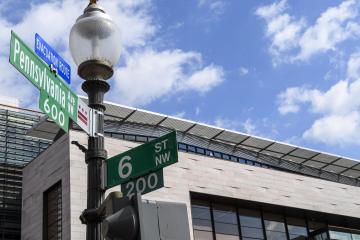 Blue skies and a Pennsylvania Avenue street sign outside the Johns Hopkins University Bloomberg Center at 555 Pennsylvania Ave.