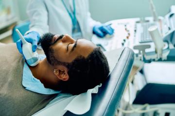 African American male patient during ultrasound thyroid gland examination at the clinic