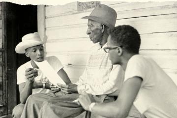 A closeup of the cover of 'Before the Movement' features an old photo of three Black men sitting on a porch