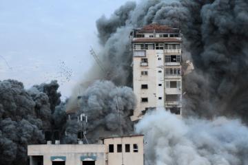 Buildings in Gaza are surrounded by smoke during an aerial bombing.