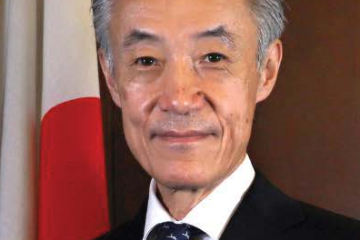 Official photo of Ambassador Shigeo YAMADA, an older Japanese man in a suit sitting in front of a Japanese flag