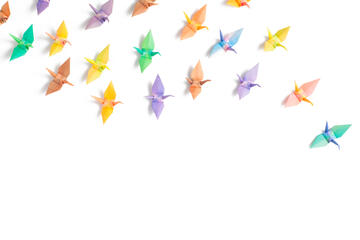 pastel-colored paper cranes arranged on a white background