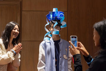 Students work on a team-building project using plastic cups during 