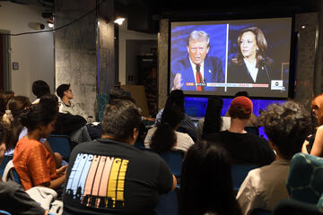 Students gather in front of a big-screen TV to watch the presidential debate on Sept. 10