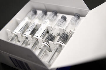 A white box containing flu shot syringes