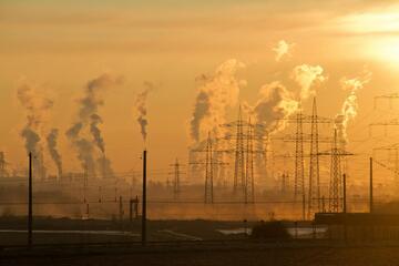 Smoke billows from the factories' flue stacks