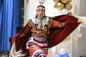 A Native American dancer from the Piscataway Nation performs while dressed in traditional clothes.