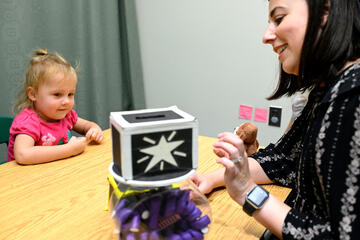 A toddler gets ready to select a toy from the machine, during the experiment.