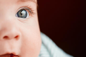 Baby with blue eyes looking away