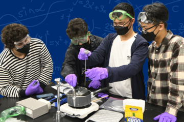 Photograph of a group of students perform a lab experiment