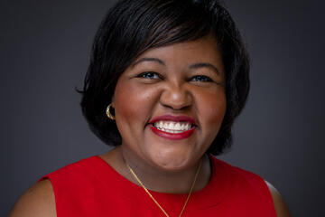 Headshot of a woman in a red dress