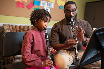 A Peabody Prep instructor and student playing the clarinet.