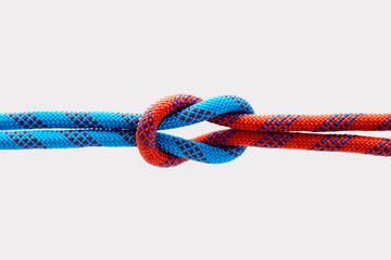 Rope with reef knot isolated on white background.