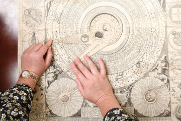 Rachel Williams, a Stern Center Curatorial Fellow, works with a 17th-century “paper supercomputer” created by Italian friar Vincenzo Maria Coronelli. By twisting its wheels, users can perform complex astrological and astronomical calculations, determine Catholic feast days, and more.