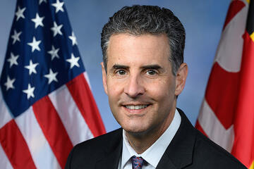 John Sarbanes portrait with the American and Maryland flags in the background