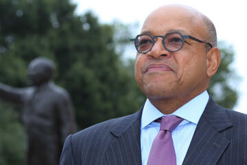 A man in a purple tie and glasses