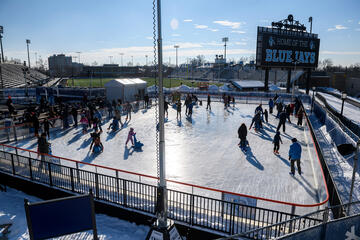 Skaters enjoy an outdoor ice skating rink