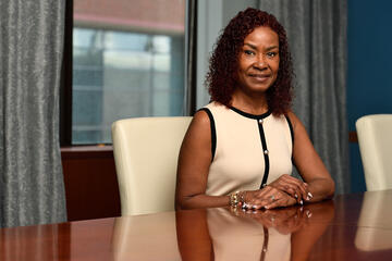 Adriane Smith seated at a conference room table