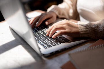 Woman's hands on a laptop keyboard