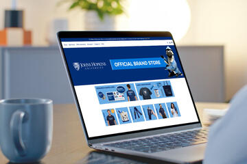 Laptop open to show brand store webpage on the screen