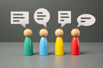 Wood figures with conversation bubbles over their heads