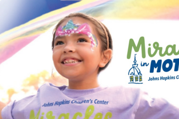 A smiling young girl with face paint next to the words "Miracles in Motion 5K"