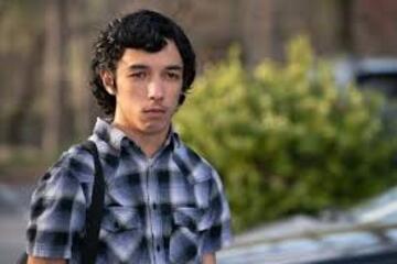 A boy in a blue and white checked shirt