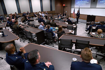 People wearing military uniforms inside of a lecture hall at Hopkins Bloomberg Center