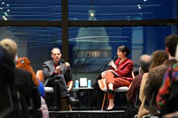 Arturo Casadevall, left, discussing his Wavelengths book, *What if Fungi Win?*, in March at the Hopkins Bloomberg Center