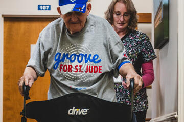 Frank Squibb uses his walker to make his way down one of the center's hallwaysFrank Squibb uses his walker to make his way down one of the center's hallways