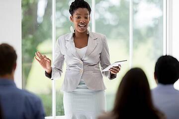 A woman speaking to a small group seated in front of her