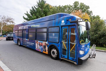 A blue electric bus in motion