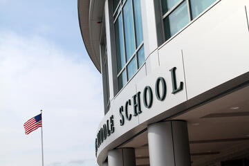 An American flag outside of a middle school building