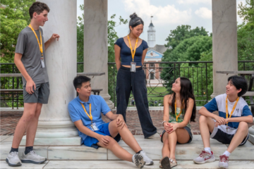 A group of students gather on the Johns Hopkins Homewood campus