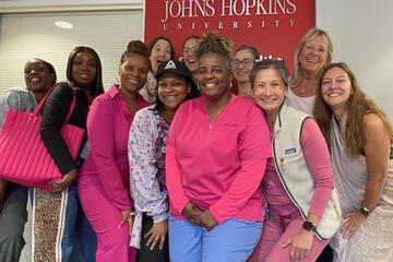 Group of employees wearing pink