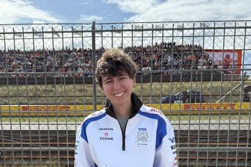 Talia Hovsepian smiles for a photo at a Formula 1 race.