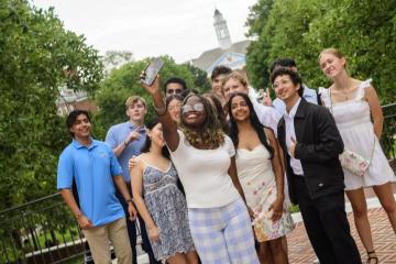 A group of college students take a selfie together.