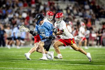 JHU men's lacrosse players competing against University of Maryland