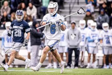 A men's lacrosse player prepares to throw the ball