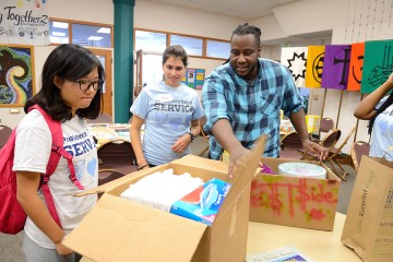 A group unpacks boxes of supplies