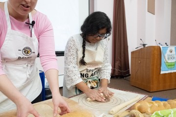 Little girl kneads bread